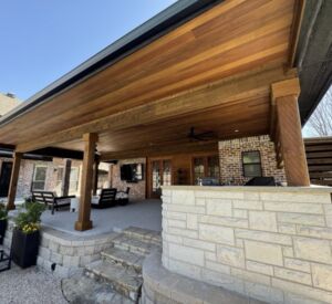 New custom build for outdoor living in Heath, Texas - patio cover, outdoor kitchen, custom wood work and stone work, plus raised beds, turf, and screens.