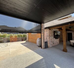 New custom build for outdoor living in Heath, Texas - patio cover, outdoor kitchen, custom wood work and stone work, plus raised beds, turf, and screens.