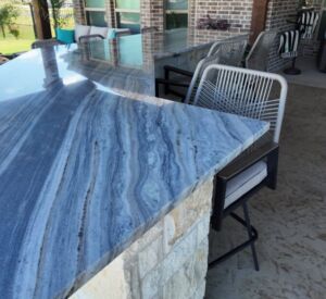 outdoor kitchen and bar with marble countertop